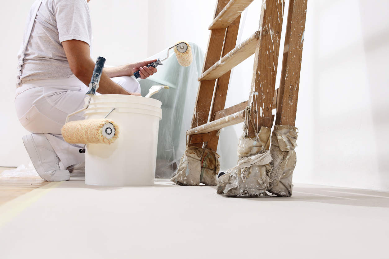 painter applying thin coats to prevent tacky paint situation